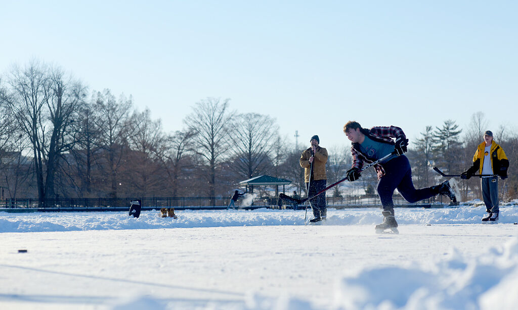 Ian Nowackay, center, takes a slap shot